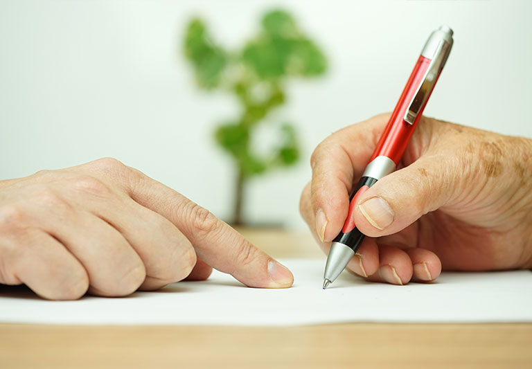 Senior receiving instructions to sign a document